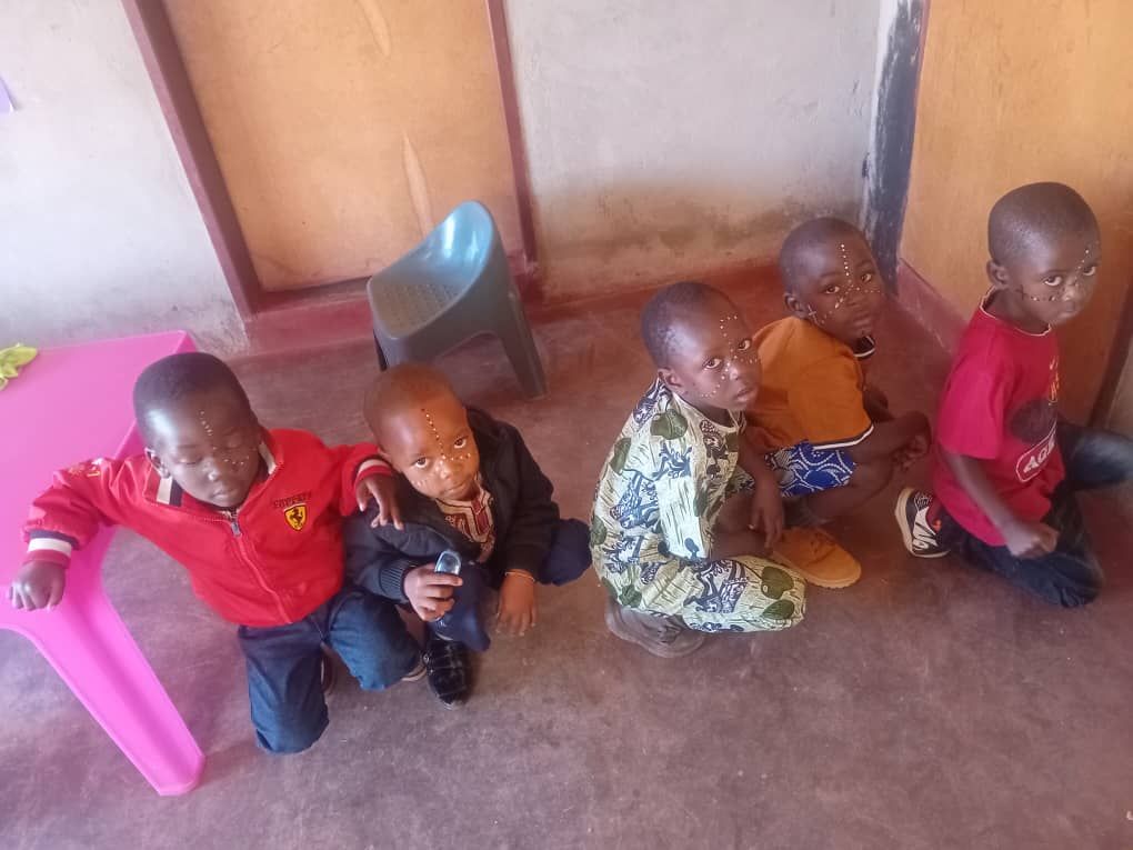 Boys with traditional face paint sitting together