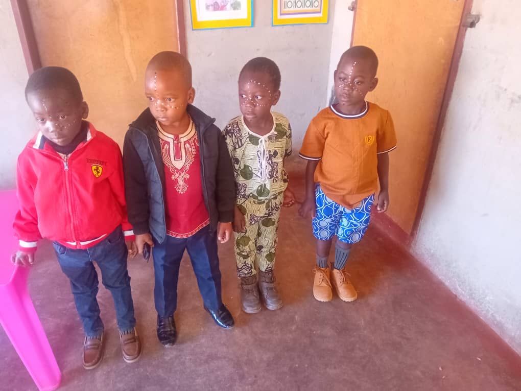 Boys dressed up with traditional face paint on Africa Day